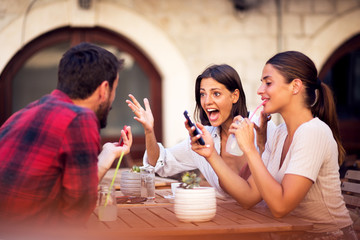 Group of friends have fun in cafe bar