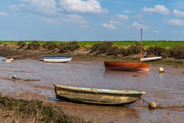 Boats in the Overy Marshes, seen in Burnham Overy Staithe, Norfolk, England, UK
