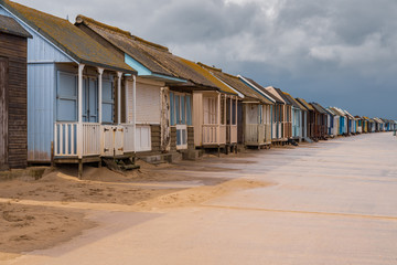 Grey clouds over the Beach Huts in Sandilands, Lincolnshire, England, UK