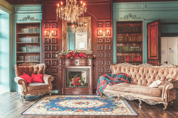 Luxury classic interior of home library. Sitting room with bookshelf, books, arm chair, sofa and...
