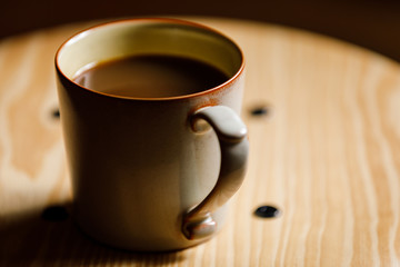 cup of coffee on wooden table