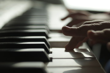 Fototapeta na wymiar children's hands are playing the piano