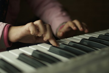 Fototapeta premium children's hands are playing the piano