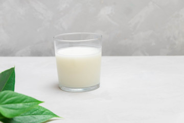 Plain ayran (kefir) fermented dairy drink on grey neutral background.