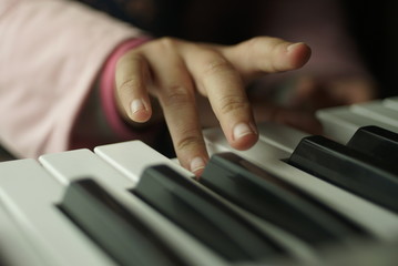 Fototapeta na wymiar children's hand are playing the piano