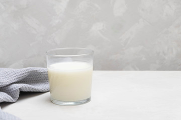 Yogurt-based beverage ayran (kefir) on grey concrete background.