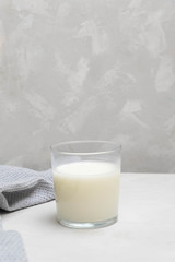 Cup of plain fermented drink ayran (kefir) on grey neutral background.