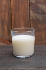 Glass of fresh turkish ayran (kefir) drink on wooden background.