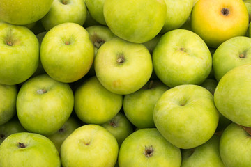 Green apples lie on a window of a market, store, supermarket