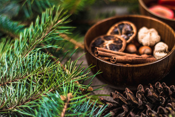 Fruit tea with cinnamon and lemon and decorations on a wooden background