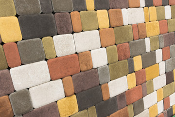 Paving slabs, stones of rectangular and square shapes of different colors laid out with patterns for equipping paths in the country as a background or texture