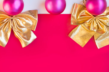 Beautiful Christmas red balls and bow decoration, on a red background.