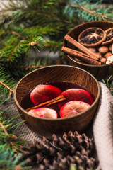 Fruit tea with cinnamon and lemon and decorations on a wooden background