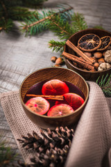 Fruit tea with cinnamon and lemon and decorations on a wooden background