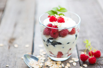 Natural yogurt with fresh raspberries, black currant and muesli.
