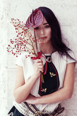 Fototapeta premium Outdoor portrait of a young glamorous fashionable woman posing on the street.