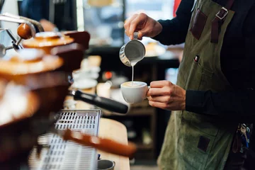 Foto op Plexiglas Muziekwinkel Barista making coffee in coffee shop, hands holding cup of coffee.