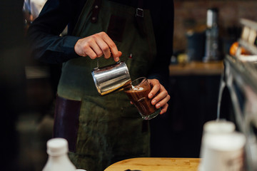Barista making cacao drink in coffee shop