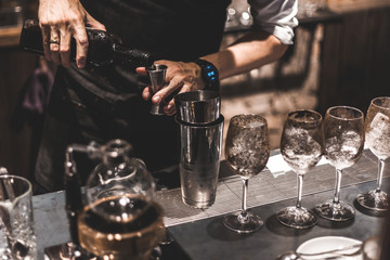 Bartender making cocktails at the bar, alcoholic drinks  