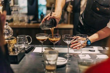 Bartender making cocktails at the bar, alcoholic drinks  