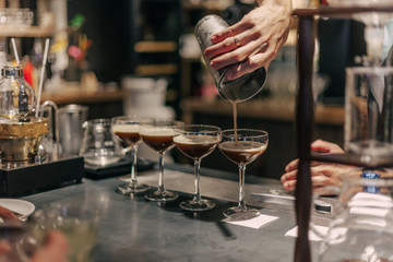 Bartender making cocktails at the bar, alcoholic drinks  