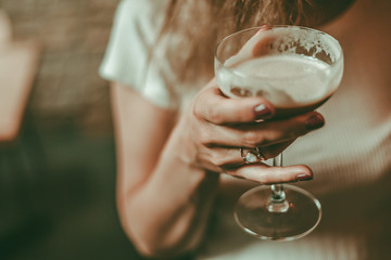 Women holding alcoholic cocktail, summer cocktail in bar