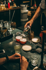 Fototapeta na wymiar Bartender making cocktails at the bar, alcoholic drinks 
