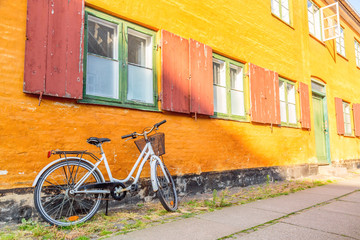 Picturesque of Copenhagen. Old yellow house of Nyboder district with bike. Old Medieval district in Copenhagen, Denmark