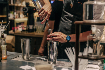 Bartender making cocktails at the bar, alcoholic drinks  