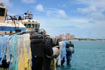 Fishing boat in the harbor. Ropes, fishing equipment. Blue sky.