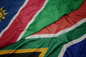 Fototapeta premium waving colorful flag of south africa and national flag of namibia.