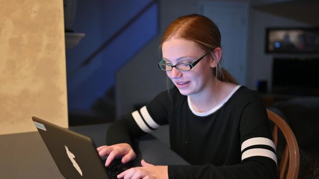 teenager, Madelyne, loves to communicate with friends on the internet. Homework can wait.