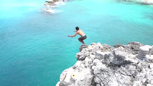 Ocean gainer cliff jump into blue lagoon, Indonesia. Shot on Sony a6500 in 120fps.