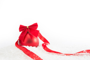 Red christmas ball with ribbon on white background.