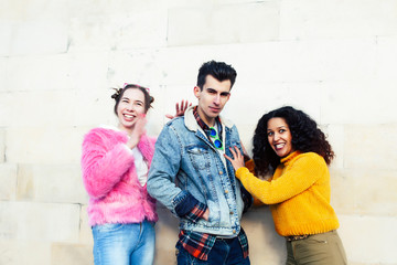 cute group of teenages at the building of university with books huggings, diversity nations real students lifestyle