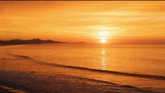 Breathtaking Time-lapse of a Golden Mystical Sunrise, Sun Launches Over the Ocean Surf