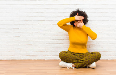 young pretty afro woman covering face with both hands saying no to the camera! refusing pictures or...