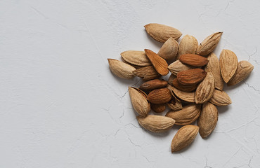 Natural organic almonds on a white background. View from above. Healthy eating concept. Natural light.