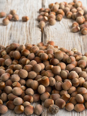 Natural organic hazelnut scattered on a wooden vintage background. Close-up. Healthy eating concept. Natural light. Food background, photo wallpaper.