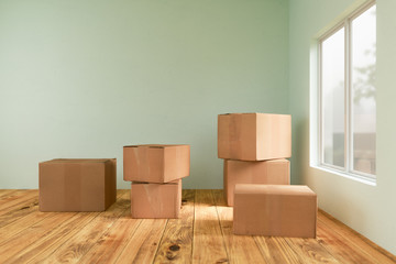 3D rendering of cardboard moving boxes on the floor in empty room