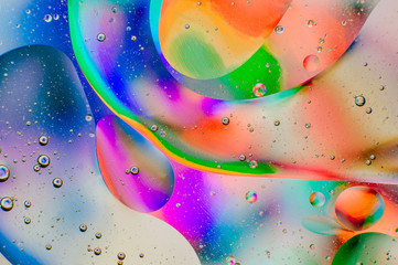 Iridescent macro background of oil drops on the water