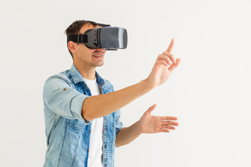Man wearing virtual reality goggles. Studio shot, white background