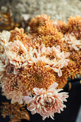 Beautiful autumn bouquet of mixed flowers with peonies. The work of the florist. Flower delivery