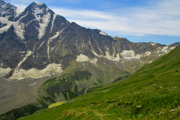 Multicolored lake between mountains of Northern Caucasus