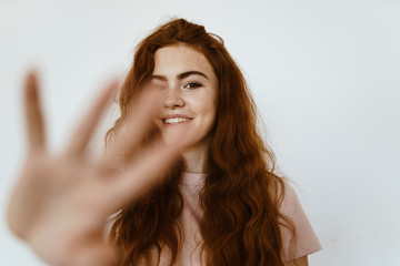 Fototapeta premium schoolgirl smiling slyly extended her hand forward and tries to close the camera