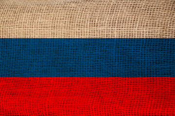 photo of the beautiful colored national flag of the modern state of Russia on textured fabric, concept of tourism, emigration, economics and politics, closeup