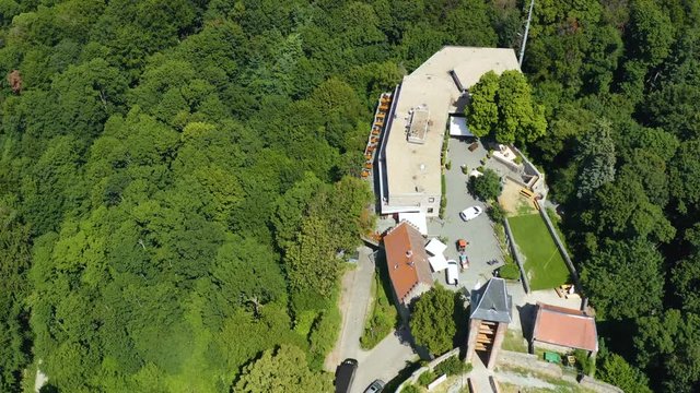 Aerial view of the castle Burg Frankenstein close to the Mühltal in Germany. On a sunny day in Summer. Tilt down above and over the castle.