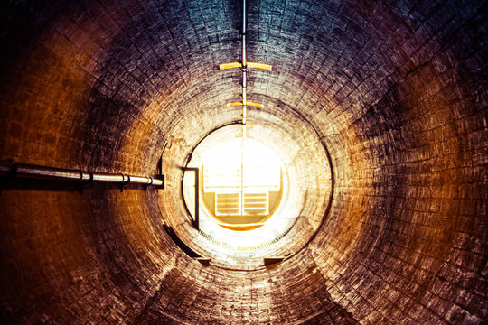 Staring Down An Old Tunnel With A Light At The End Of The Tunnel.  This Is A Ventilation Tunnel Inside The Hoover Dam.