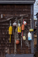 Lobster buoys hanging on a wooden barn wall - 300442224