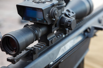 Sniper gun, optics scopes close up. Elements of the sniper rifle with tactical body.  Selective...